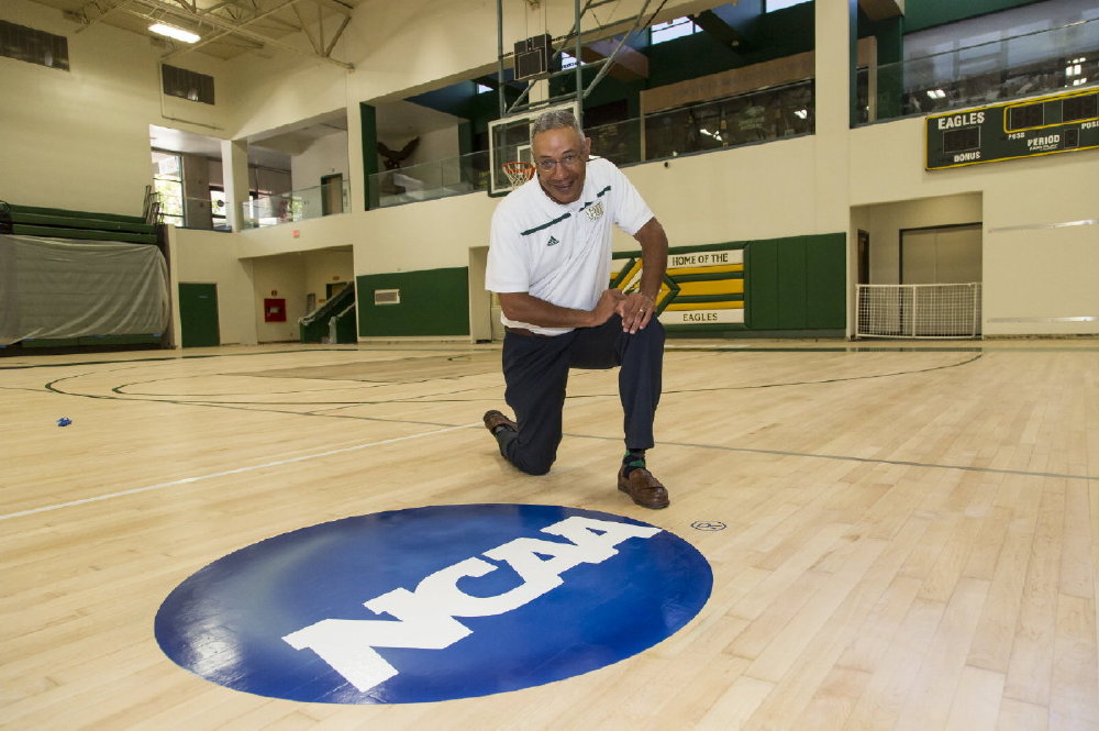 Concordia University Irvine Athletics Director Mo Roberson is featured with the distinctive NCAA logo on the university's gym floor.